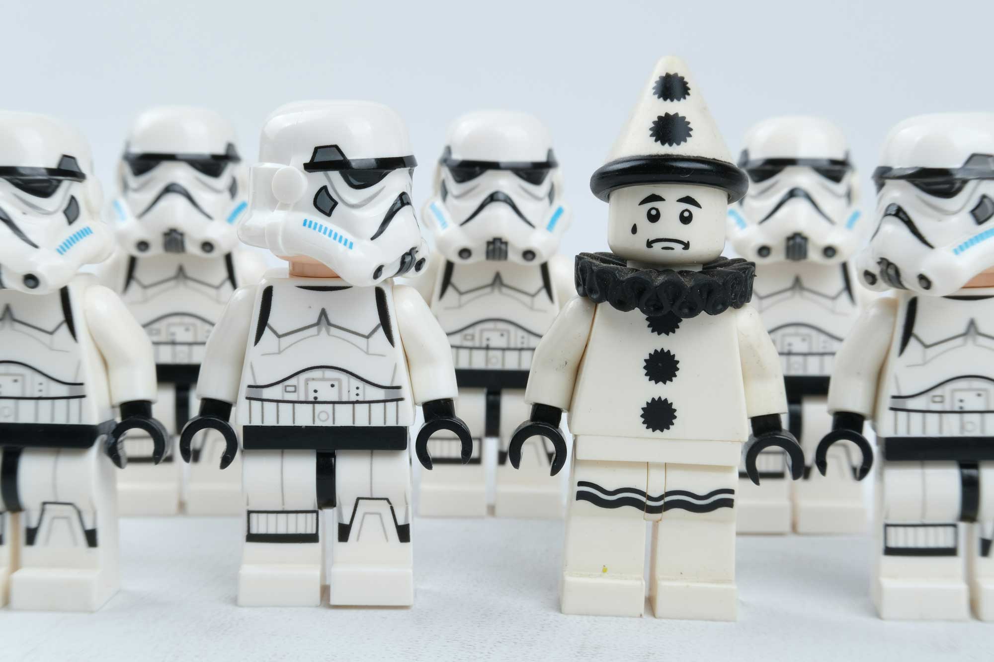 A collection of LEGO storm troopers surrounding a clown. A depiction of success in a saturated market